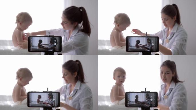 博客，受欢迎的vlogger女医生在为追随者进行婴儿体检期间在智能手机上拍摄vlog的新剧集