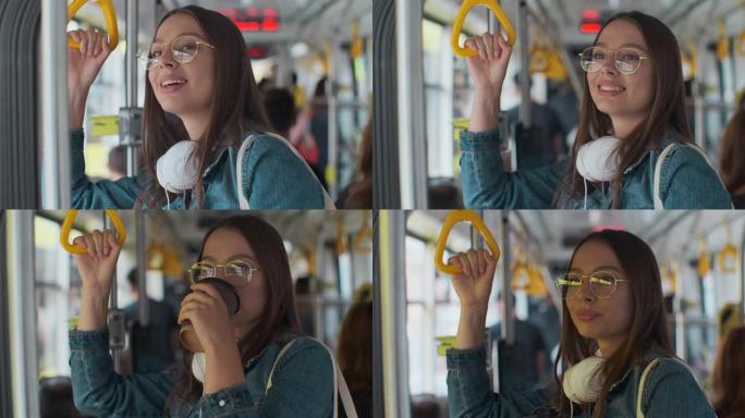 年轻时尚的女人喜欢在现代电车上旅行，站在公共交通工具上喝咖啡。