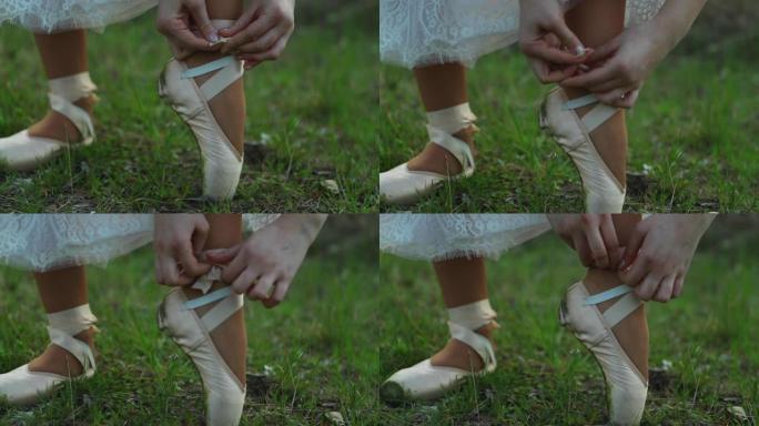 在120 fps拍摄的春季户外草地上解开和绑鞋时的芭蕾舞鞋特写视图