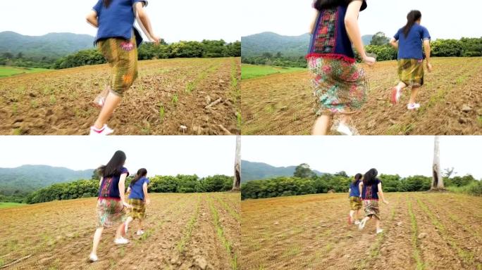 美丽的亚洲年轻女孩在可爱的阳光明媚的夏日在玉米田里奔跑