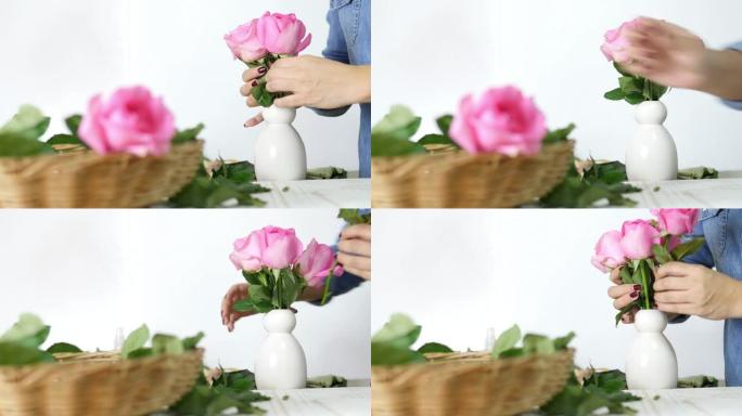 女孩快乐地把粉红玫瑰放进白色花瓶里
