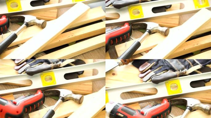 多莉射击: 木制工匠的工作工具，如锤子、防护手套、水平仪、无绳螺丝刀钻和刀