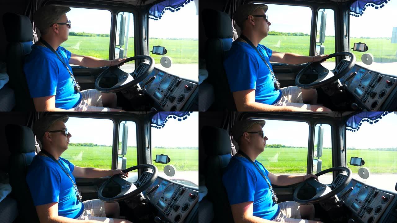 戴着墨镜的驾驶员的个人资料坐在卡车的方向盘后面，在阳光明媚的日子里骑在乡间小路上。男子控制他的卡车专