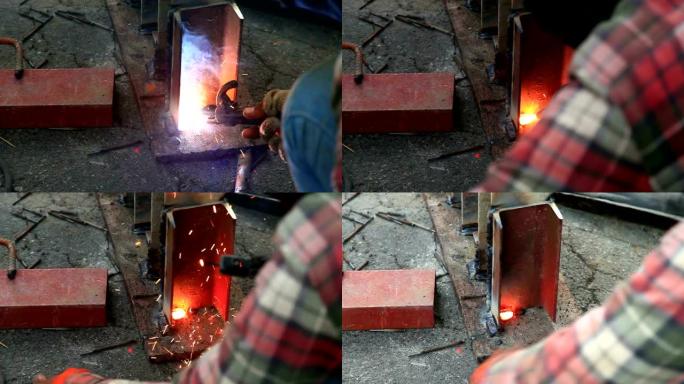 移动技术人员的特写镜头是用煤气火焊接的钢柱。