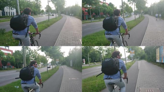 年轻的成年男子在德国雷根斯堡拉蒂斯博纳骑自行车，背着背包