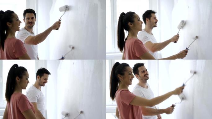 公寓里的情侣粉刷墙