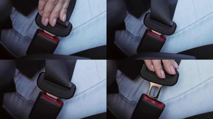 女性的手系好并解开汽车上的安全带。