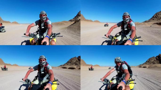 一名男子在埃及沙漠里骑四轮摩托，用动作相机拍摄自己