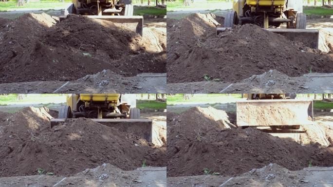 拖拉机清除土壤污垢，挖洞施工现场。