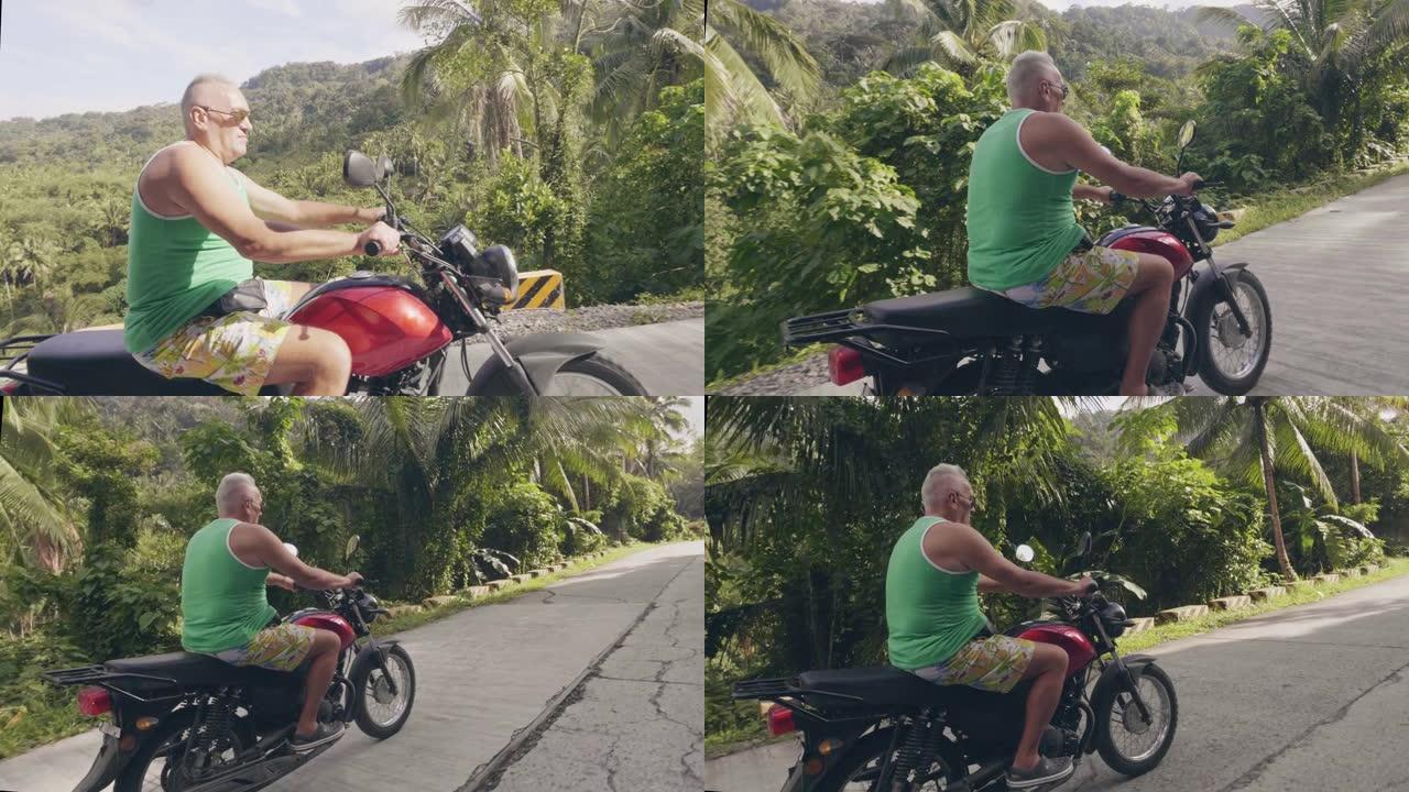 夏季摩托旅行时，老人在亚洲乡村骑摩托车。旅游男子骑摩托车在热带雨林景观。