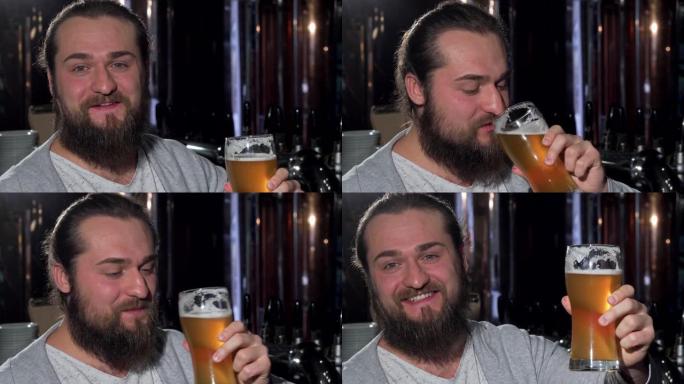 大胡子快乐的男人微笑着，将啤酒杯举到相机上