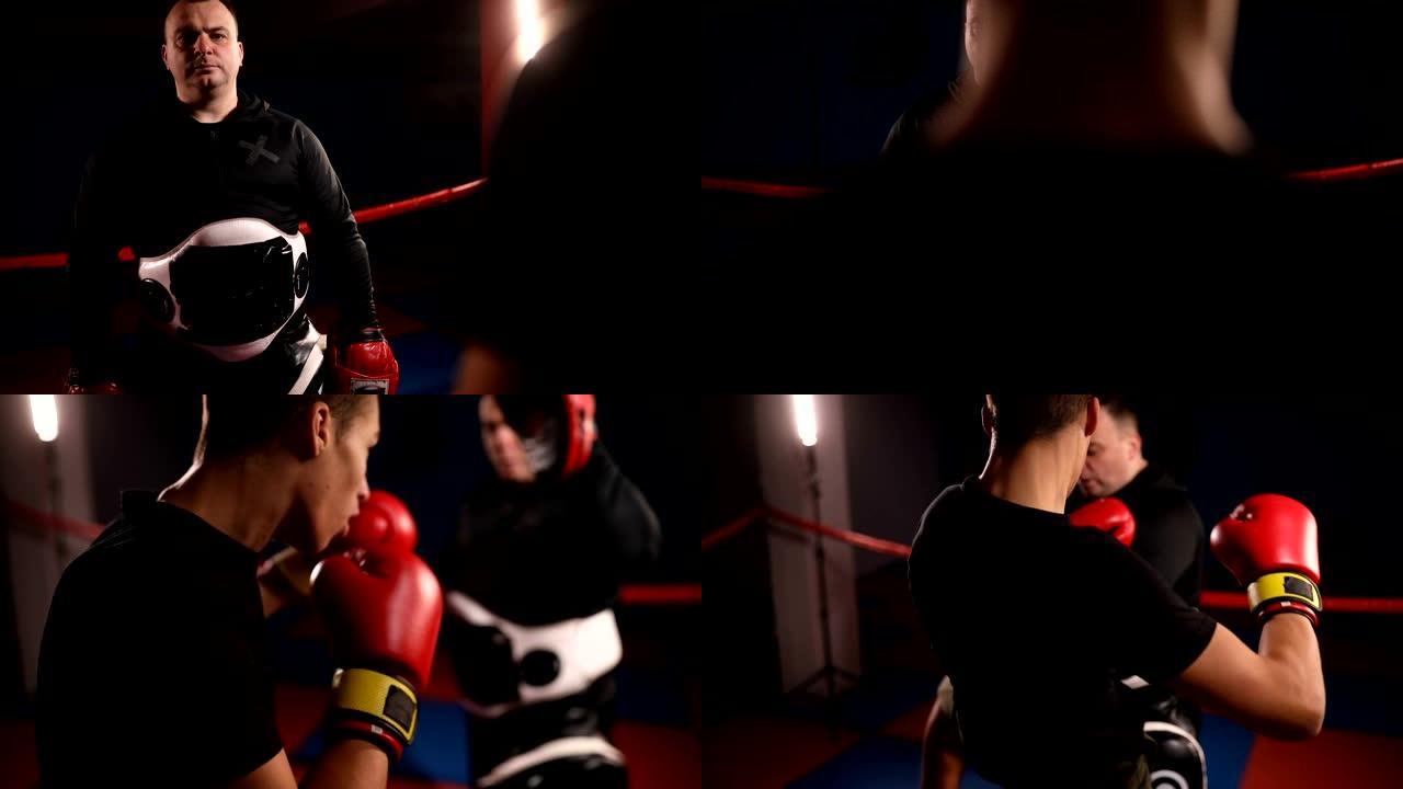 在黑暗的体育馆里与教练一起训练年轻的拳击手