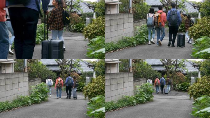 一群年轻的亚洲游客抵达日式旅馆