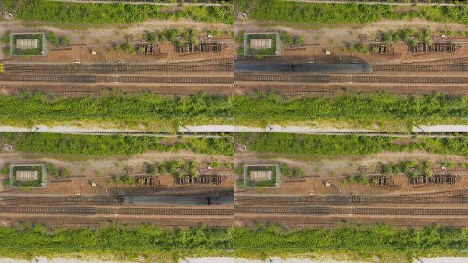 空中4k镜头低头看着一列旅客列车从下方驶向谢菲尔德市