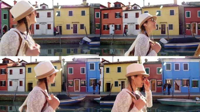 单人旅行者，在意大利威尼斯布拉诺岛上散步的年轻女性游客。浪漫之城及其典型的威尼斯景点。