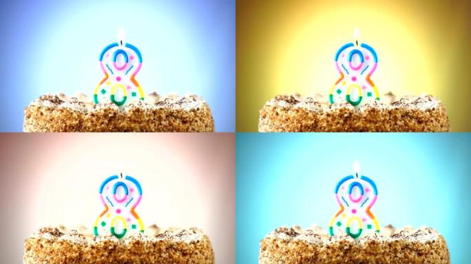 带有燃烧的生日蜡烛的生日蛋糕。8号。背景改变颜色