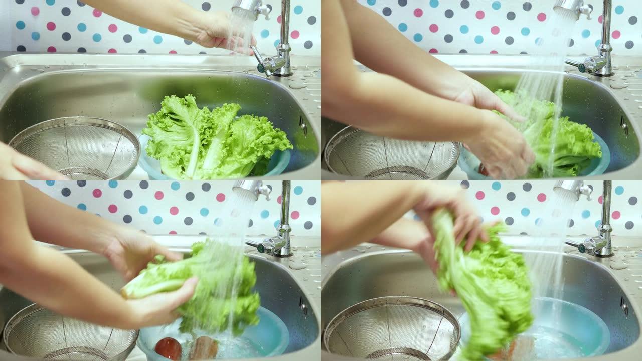 女士在家庭厨房用喷水清洗新鲜蔬菜