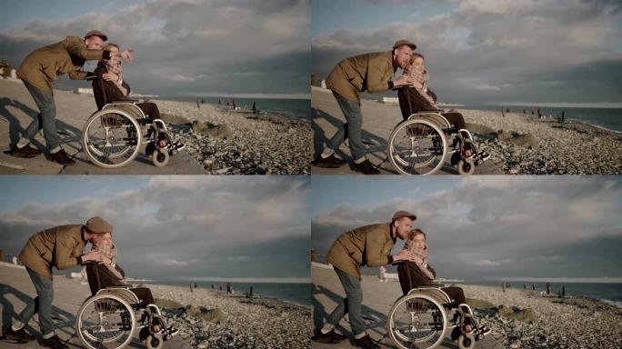 男人抱着他的妻子坐在海堤上的无效马车上