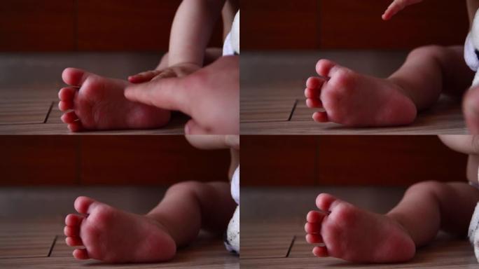 婴儿脚和母亲手指的特写