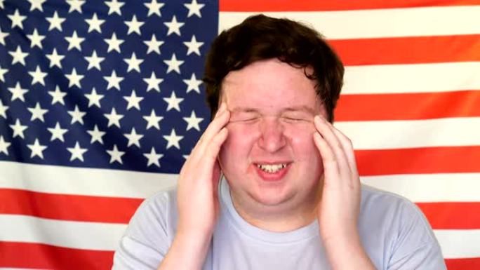 一个年轻人在美国国旗的背景上头疼