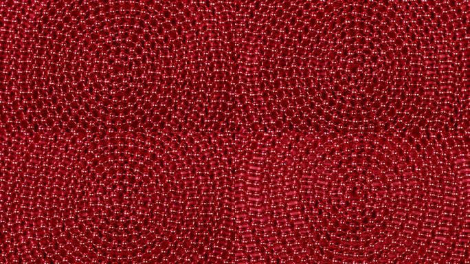 躺在红布上的红色珠子螺旋旋转。