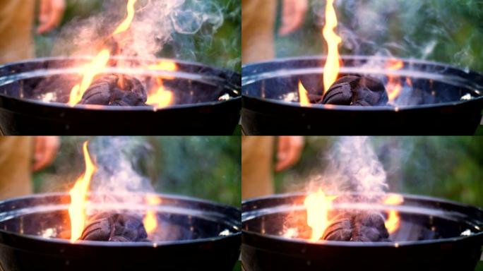 烧烤架的特写镜头，里面烧木头