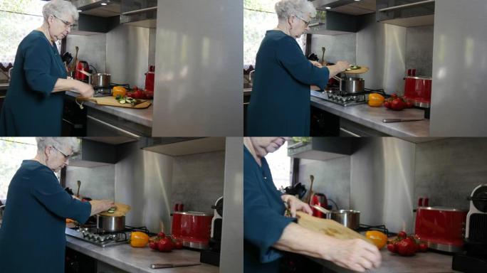 快乐的高级活跃女性在现代厨房在家做饭