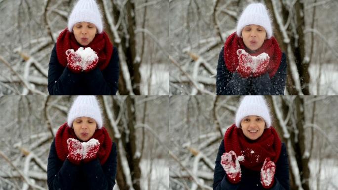 穿着白色针织帽，红领巾和连指手套的年轻女孩吹雪