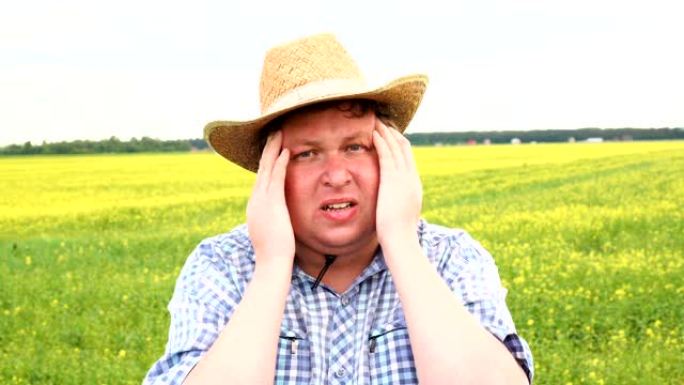 特写悲伤的年轻农民带着担心的紧张表情。戴着牛仔帽头痛的男人。