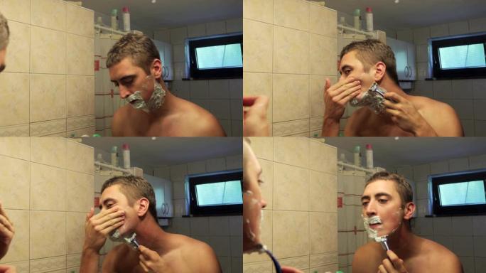 年轻成年男子用剃须刀刮胡子