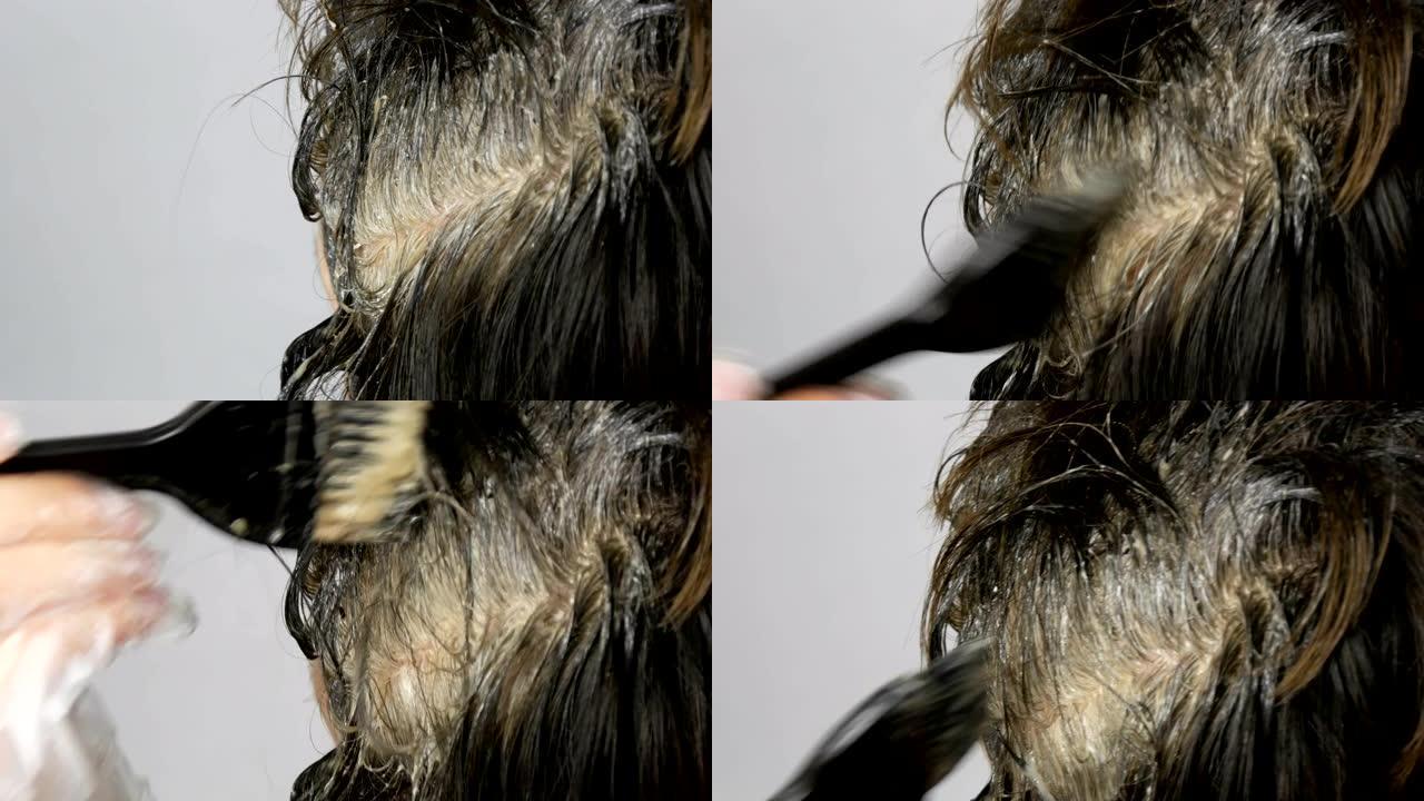 一名中年妇女长满了灰色的根，她用特殊的刷子将自己的头发涂在身上，看起来很近距离