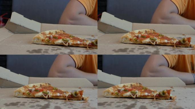 特写最后一片披萨放在一个人背景下的披萨盒里。4k。4k视频