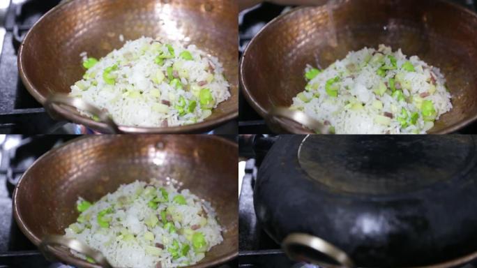 厨师用平底锅烹饪蔬菜炒饭