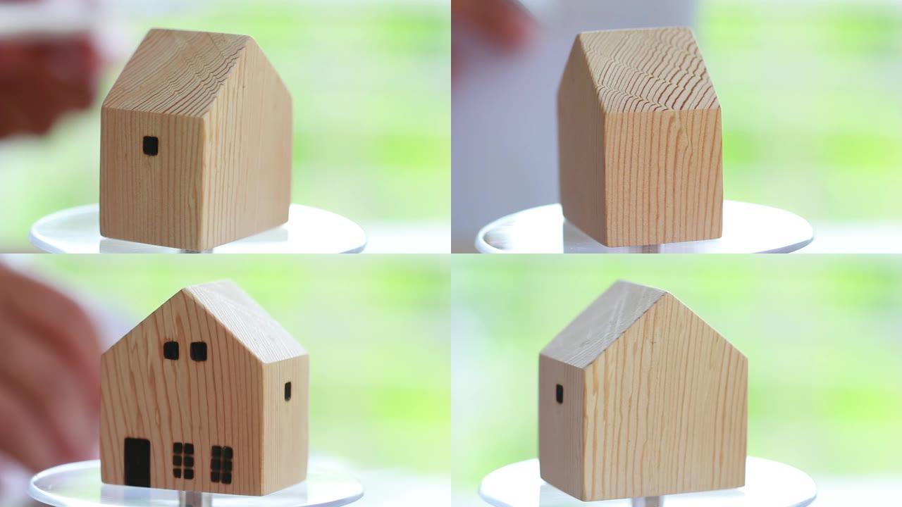 房地产物业概念: 旋转木房子模型展示出售。提供抵押贷款投资和管理协议以及购买新房的行业建设的想法。