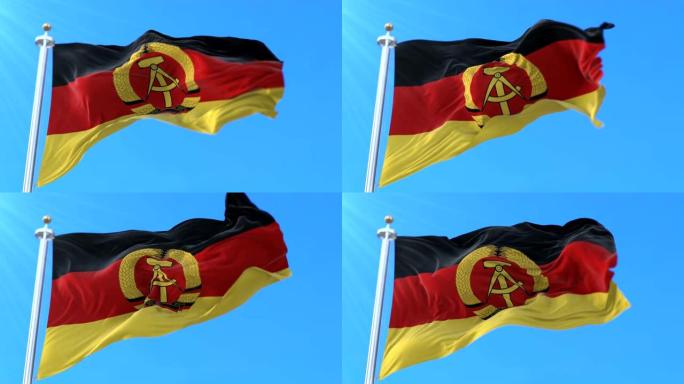 在蓝天中挥舞的德意志民主共和国或东德国旗。循环