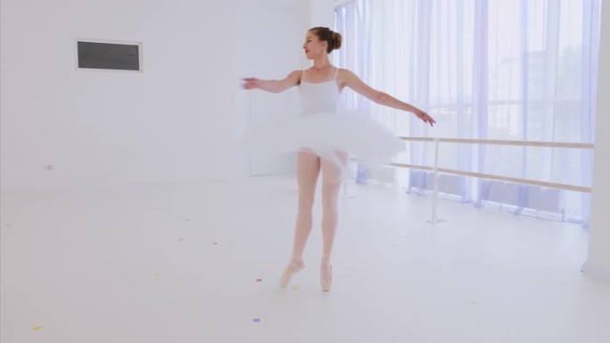 穿着白色芭蕾舞短裙和poines的芭蕾舞女演员在芭蕾舞课上跳舞。