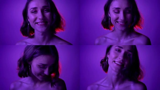 霓虹紫色背景下，年轻诱人的女性在镜头前诱人微笑的特写镜头