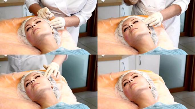 医疗诊所。年轻的女性客户得到螺纹整容程序。美容师戴手套做脸抗衰老女性脸
