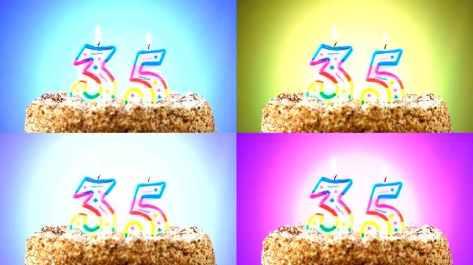 带有燃烧的生日蜡烛的生日蛋糕。35号。背景改变颜色