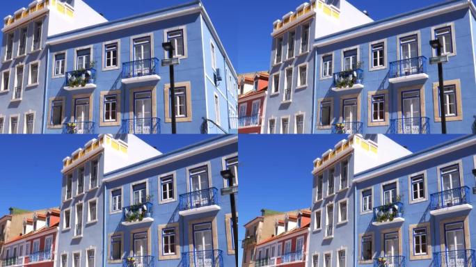 在阳光明媚的夏日，在葡萄牙阿尔马达的cacilhs平移五颜六色的建筑立面。