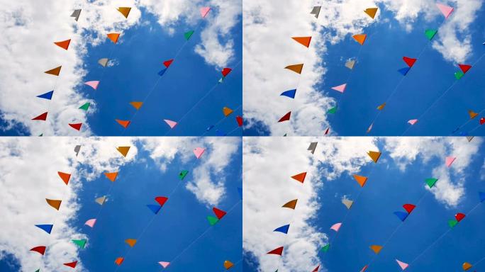 蓝色天空背景上的三角旗在风中挥舞