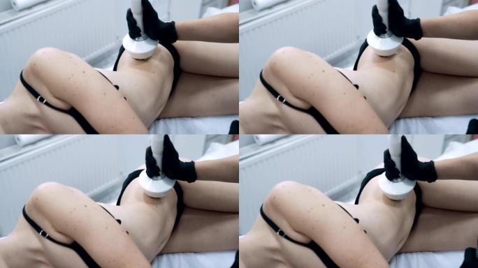 特写美容师的手对年轻女子做抗脂肪的手术，慢动作