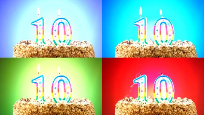 带有燃烧的生日蜡烛的生日蛋糕。10号。背景改变颜色