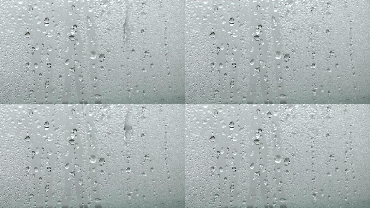 关闭玻璃窗上有雨滴的蒸汽镜，雨季背景