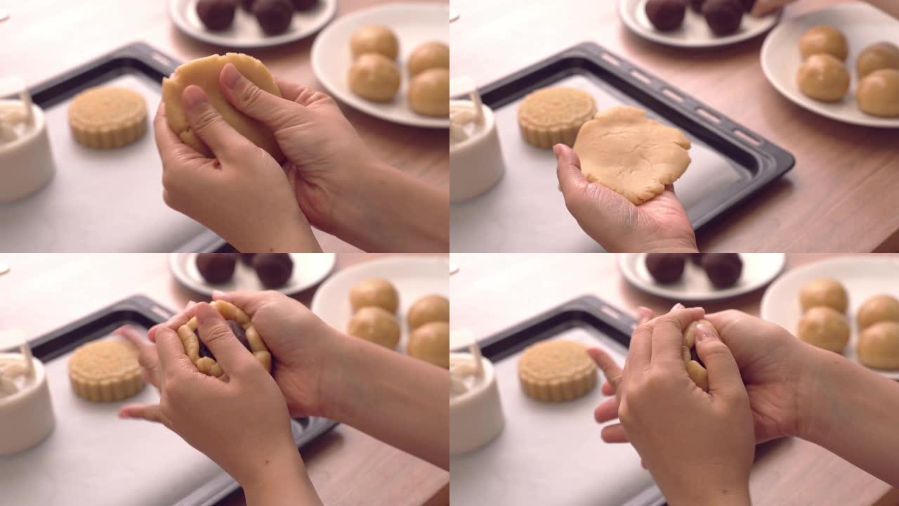 这名妇女正在用红豆沙包着月饼皮，这是传统中秋节的节日烘焙。