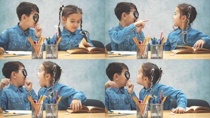 好奇的小男孩微笑着用放大镜检查他的妹妹。他们在玩耍，做鬼脸。