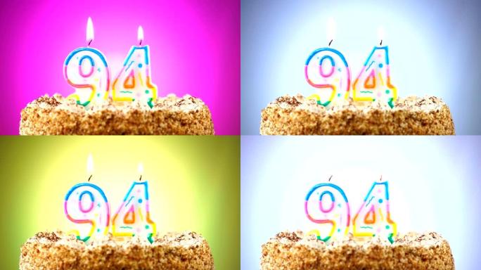 带有燃烧的生日蜡烛的生日蛋糕。94号。背景改变颜色