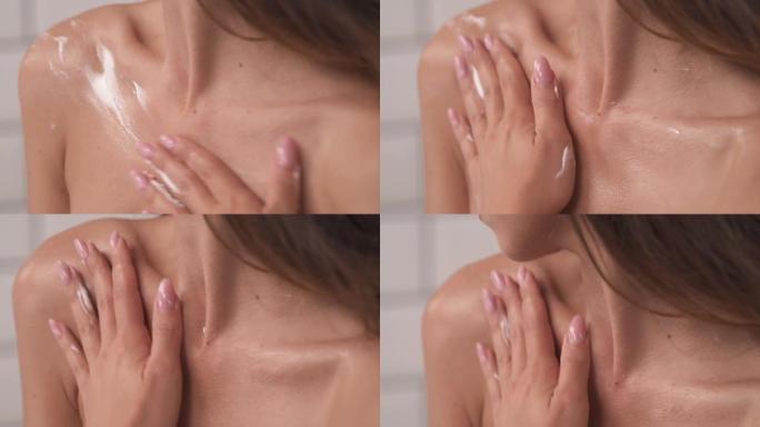 女人的手在脱色区涂抹保湿霜的特写演示视频。身体护理。
