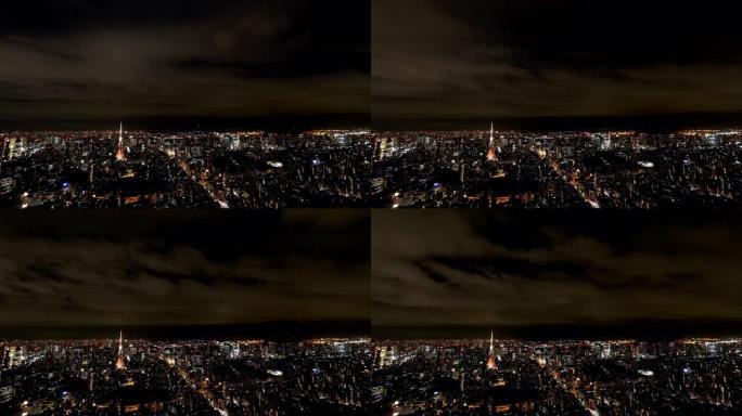 从日本东京六本木山夜间，摩天大楼城市景观商业金融大楼和东京塔上移动云的4k延时宽镜头高角度鸟瞰图