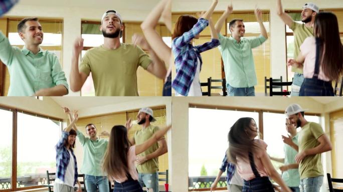 四个快乐的多元化朋友在家庭聚会上跳舞，举起手臂并唱歌唱歌的镜头